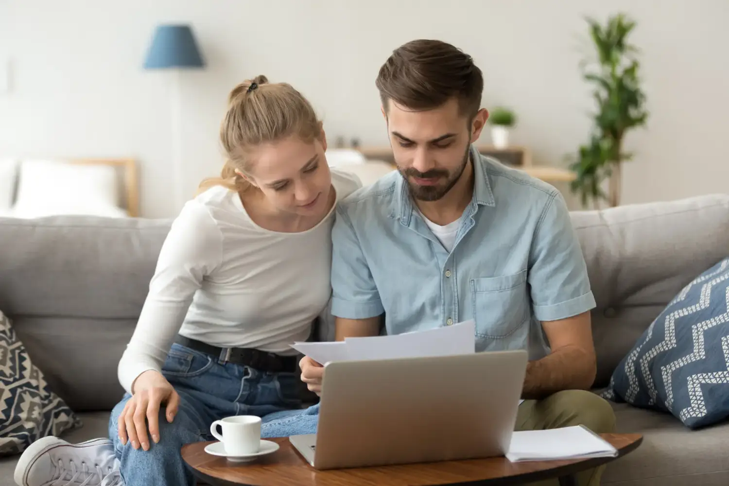 A young couple compares financing options on their computer.